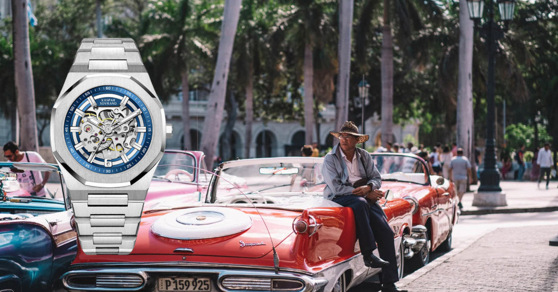 Luxury automatic watch showcased against vintage cars and palm trees.